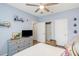 Bright bedroom boasts a dresser with a TV, a ceiling fan, and two closets, perfect for storage and relaxation at 45 Sycamore Ave # 536, Charleston, SC 29407