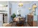 Charming dining room with a stylish light fixture, wooden table and decorative mirror at 45 Sycamore Ave # 536, Charleston, SC 29407