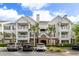 Attractive multi-story condo building featuring balconies, palm trees, and well-maintained landscaping at 45 Sycamore Ave # 536, Charleston, SC 29407