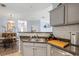 Functional kitchen space with stainless appliances, stylish backsplash, and view to dining area at 45 Sycamore Ave # 536, Charleston, SC 29407