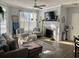Bright living room featuring a fireplace, ceiling fan and natural light from the large window at 45 Sycamore Ave # 536, Charleston, SC 29407