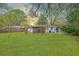 Expansive backyard with a screened porch, mature trees and lush green lawn offers a serene outdoor space at 5337 Hartford Cir, North Charleston, SC 29405
