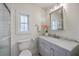 Bright bathroom with marble top vanity, decorative flowers, and framed mirror at 5337 Hartford Cir, North Charleston, SC 29405