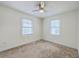Bright room with neutral carpet, ceiling fan, and two windows for ample light at 5337 Hartford Cir, North Charleston, SC 29405