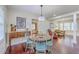 Inviting dining room featuring a wood table with light blue chairs, hardwood flooring, and plenty of natural light at 5337 Hartford Cir, North Charleston, SC 29405