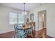 Cozy dining room with hardwood floors, a wooden table, and four light blue chairs near a window at 5337 Hartford Cir, North Charleston, SC 29405