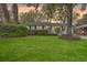 Charming single-story home featuring a lush green lawn, mature trees, and manicured landscaping at 5337 Hartford Cir, North Charleston, SC 29405