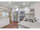Well-lit kitchen with white cabinets, stainless steel appliances, granite countertops and hardwood floors at 5337 Hartford Cir, North Charleston, SC 29405