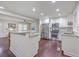 Modern kitchen with granite countertops, stainless steel appliances, white cabinets, and hardwood floors at 5337 Hartford Cir, North Charleston, SC 29405
