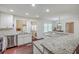 Spacious kitchen with granite counters, stainless appliances, white cabinets, and hardwood floors at 5337 Hartford Cir, North Charleston, SC 29405