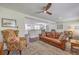 Inviting living room showcases hardwood floors, ceiling fan, and a leather couch with decorative pillows at 5337 Hartford Cir, North Charleston, SC 29405