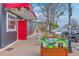Irish pub facade features a vibrant red door and awning, accented by Guinness planters and sidewalk seating at 5337 Hartford Cir, North Charleston, SC 29405