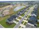 An aerial view of a planned community featuring modern homes, green spaces, and a scenic pond at 603 Dunswell Dr, Summerville, SC 29486