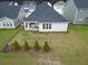 A charming home features a well-manicured backyard with green grass and small trees at 603 Dunswell Dr, Summerville, SC 29486