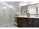 Stylish bathroom with double sinks, framed mirror, and glass shower adorned with coastal decor at 603 Dunswell Dr, Summerville, SC 29486