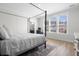 Light-filled bedroom with a four-poster bed, wood floors, and bright, airy decor at 603 Dunswell Dr, Summerville, SC 29486