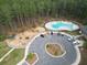 Aerial view of community pool, playground, and parking area amidst a lush forest setting at 603 Dunswell Dr, Summerville, SC 29486