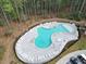 Aerial view of resort-style community pool with lounge chairs amidst a lush forest setting at 603 Dunswell Dr, Summerville, SC 29486