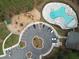 Aerial view of community pool, playground, and parking area amidst a lush forest setting at 603 Dunswell Dr, Summerville, SC 29486