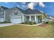 Charming single-Gathering home featuring a manicured lawn, attached garage, and a welcoming front porch at 603 Dunswell Dr, Summerville, SC 29486