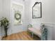 Bright foyer with wood floors, bench seating, stylish mirror, and views of the front yard at 603 Dunswell Dr, Summerville, SC 29486