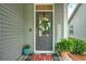 Charming front door with a wreath, a welcome sign, potted plants, and a gray exterior at 603 Dunswell Dr, Summerville, SC 29486