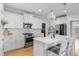 Well-lit kitchen with white cabinetry, stainless steel appliances, and an island with bar seating at 603 Dunswell Dr, Summerville, SC 29486