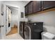 Modern laundry room featuring front load washer/dryer and cabinetry for organized storage at 603 Dunswell Dr, Summerville, SC 29486