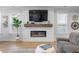 Living room with a modern electric fireplace, a large TV, and bright windows for ample natural light at 603 Dunswell Dr, Summerville, SC 29486