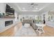 Spacious living room featuring a modern fireplace, tray ceilings, comfortable seating, and hardwood floors at 603 Dunswell Dr, Summerville, SC 29486