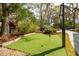 Backyard with a putting green, basketball court, and surrounded by trees at 630 Cain Dr, Mount Pleasant, SC 29464
