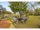 Landscaped backyard featuring a fire pit with chairs and a playground at 630 Cain Dr, Mount Pleasant, SC 29464