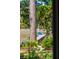 Scenic backyard view featuring a private dock, cozy blue chairs, and lush greenery at 630 Cain Dr, Mount Pleasant, SC 29464