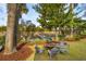 Lush backyard featuring an outdoor fire pit, ample seating, and a serene dock overlooking the marsh at 630 Cain Dr, Mount Pleasant, SC 29464