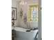 Relaxing bathroom featuring a freestanding tub, stained glass window, and elegant chandelier at 630 Cain Dr, Mount Pleasant, SC 29464