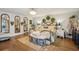 Spacious bedroom with a wrought iron bed, hardwood floors, decorative mirrors, and abundant natural light at 630 Cain Dr, Mount Pleasant, SC 29464