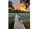 Private dock on the river highlighted by colorful sunrise and a beautiful marsh view at 630 Cain Dr, Mount Pleasant, SC 29464