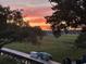 Wooden dock view showcasing the sunset sky, lush marsh views, and providing direct access to waterfront activities at 630 Cain Dr, Mount Pleasant, SC 29464