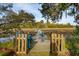 Wooden dock with blue chairs and a gate overlooking water and marshland at 630 Cain Dr, Mount Pleasant, SC 29464