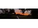 Waterfront at dusk with a long private dock leading to marsh and trees, beneath a stunning orange sky at 630 Cain Dr, Mount Pleasant, SC 29464