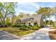 Beautifully landscaped home exterior featuring lush greenery and a curved driveway at 630 Cain Dr, Mount Pleasant, SC 29464