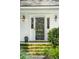 Charming front entrance with a decorative door, sidelights, and meticulously maintained landscaping at 630 Cain Dr, Mount Pleasant, SC 29464