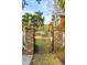 Charming brick garden gate with pineapple finials, inviting access to the well landscaped property at 630 Cain Dr, Mount Pleasant, SC 29464