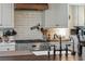 Well-appointed kitchen with white cabinets, stainless steel appliances, and brick backsplash at 630 Cain Dr, Mount Pleasant, SC 29464