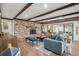 Cozy living room with exposed brick fireplace, wood beams, and comfortable seating at 630 Cain Dr, Mount Pleasant, SC 29464