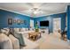 Cozy living room with blue walls, a large sofa, and a decorative ceiling fan at 630 Cain Dr, Mount Pleasant, SC 29464