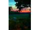 Lovely waterfront property with marsh view at dusk with dock, boat and kayak at 630 Cain Dr, Mount Pleasant, SC 29464