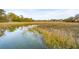 Marshland with water in the foreground and beautiful homes across the marsh at 630 Cain Dr, Mount Pleasant, SC 29464