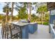 Entertain in this outdoor kitchen, featuring a grill, bar seating, and views of the marsh at 630 Cain Dr, Mount Pleasant, SC 29464