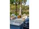 Inviting outdoor seating area with a wooden barrel table, comfortable chairs, and tranquil marsh views at 630 Cain Dr, Mount Pleasant, SC 29464